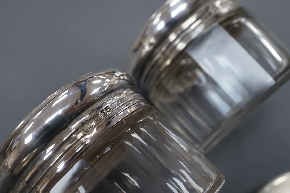 A George V oval silver trinket box, Adie Bros. Birmingham, 1922, 10.8cm, together with a silver compact, four assorted silver mounted toilet jars and a silver mounted hair brush.